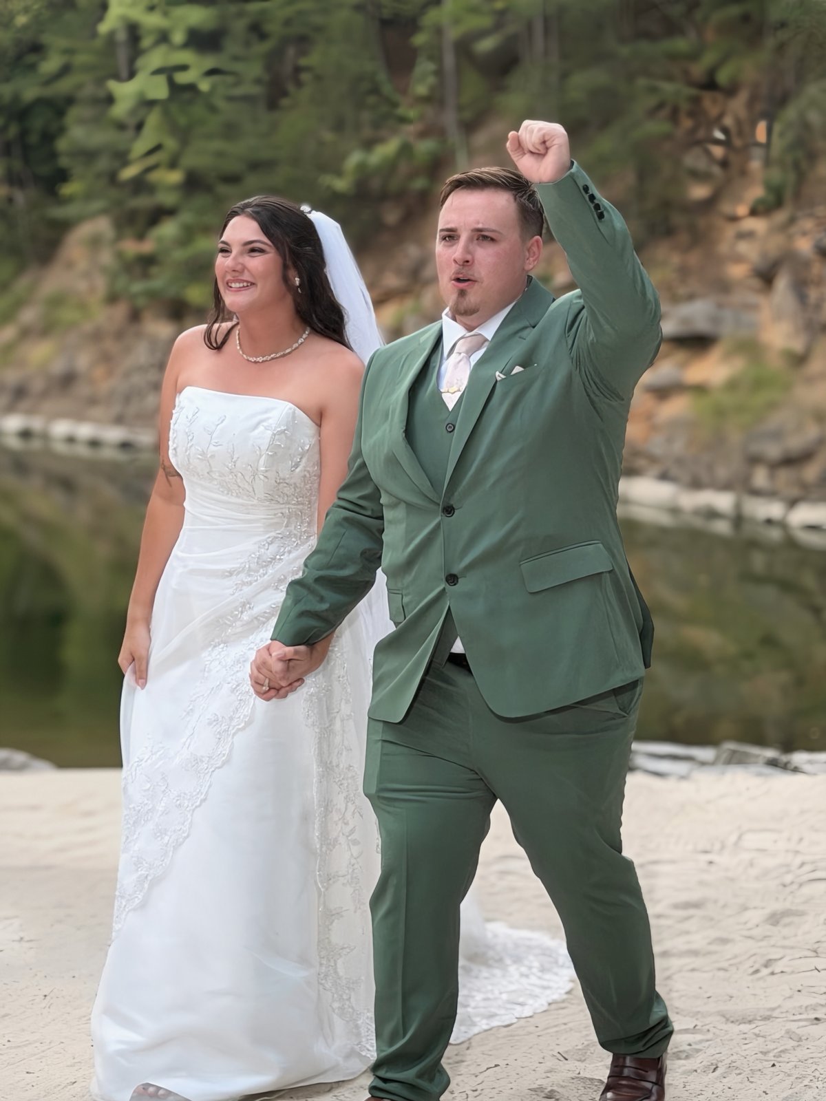 Ashleigh and Robert celebrating hand in hand after the ceremony